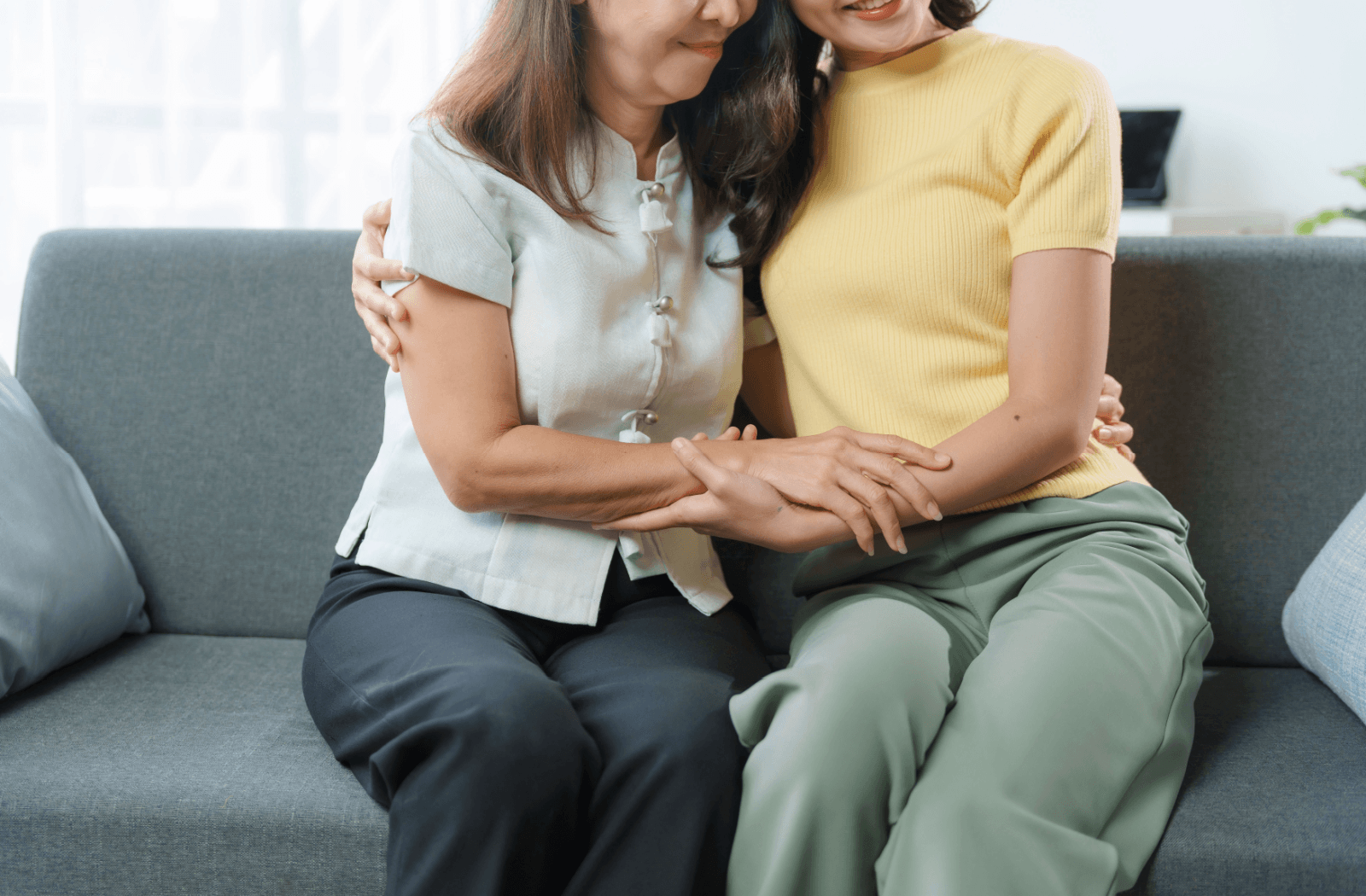A senior is comforted by their adult child after experiencing a hallucination.