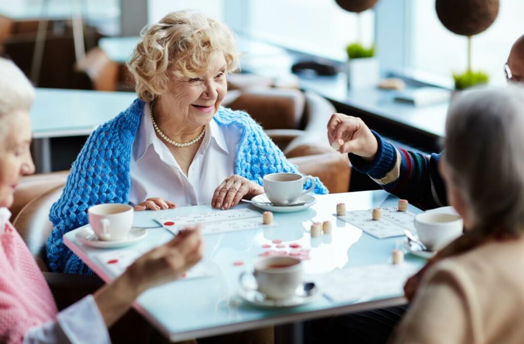 A group of older adults playing a game together at an assisted living cafe.