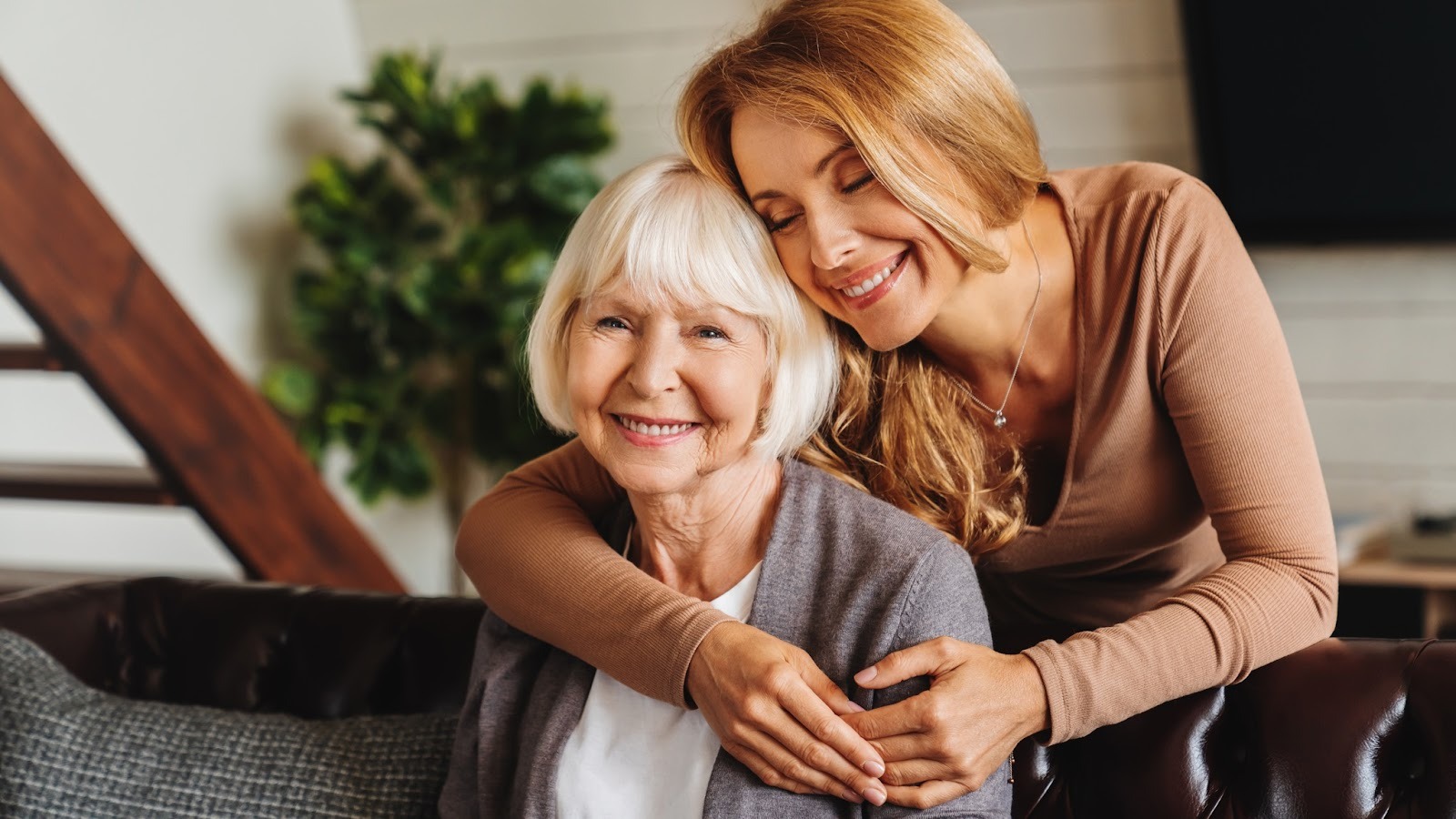 a carer hugs her senior parent